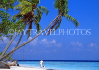 MALDIVE ISLANDS, beach scene with leaning coconut trees, and tourist with child, MAL726JPL