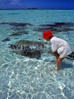 MALDIVE ISLANDS, boy looking at coral in shallow water, MAL517JPL
