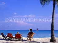 MALDIVE ISLANDS, deckchairs and tourists on beach, MAL699JPL
