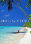 MALDIVE ISLANDS, holidaymaker on beach, under coconut tree shade, MAL223JPL