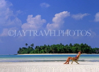 MALDIVE ISLANDS, holidaymaker sunbathing on strip of beach, MAL705JPL