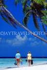 MALDIVE ISLANDS, typical island, couple along beach, coconut trees, MAL755JPL