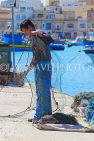 MALTA, Marsaxlokk, fishing village, fisherman sorting out fishing nets, MLT1039JPL