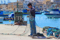 MALTA, Marsaxlokk, fishing village, fisherman sorting out fishing nets, MLT1114JPL