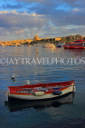 MALTA, Sliema, seafront, sunset and boat, view towards Valletta, MLT829JPL
