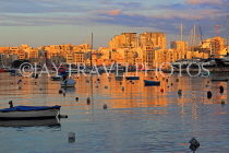 MALTA, Sliema, seafront, sunset and boats, view towards Valletta, MLT826JPL