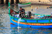MALTA, St Julian's, fisherman in his boat (Luzzu), MLT1165JPL