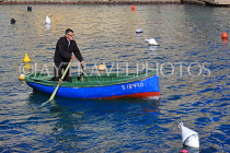 MALTA, St Julian's, man rowing a small boat, MLT1167JPL
