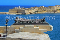 MALTA, Valletta, Seige Bell War Memorial, unknown soldier statue, view of Fort Ricasoli , MLT858JPL