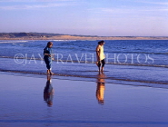 MOROCCO, Agadir, beach and Moroccan people paddling at dusk, MOR289JPL