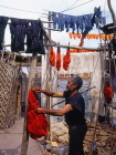MOROCCO, Marrakesh, Medina (old town), man drying coloured wool, MOR309JPL