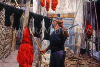 MOROCCO, Marrakesh, Medina (old town), man drying coloured wool, MOR310JPL