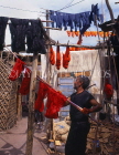 MOROCCO, Marrakesh, Medina (old town), man drying coloured wool, MOR311JPL