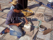 MOROCCO, Marrakesh, Royal palace (Bahia), worker repairing mosaic floor, MOR327JPL