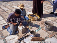 MOROCCO, Marrakesh, Royal palace (Bahia), worker repairing mosaic floor, MOR328JPL