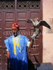 MOROCCO, Marrakesh, man posing with bird of prey, MOR345JPL