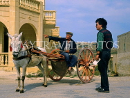 Malta, GOZO, farmer in donkey drawn cart, offering directions to man, MLT36JPL