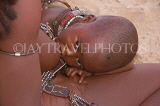 NAMIBIA, Himba tribe mother breastfeeding baby, NAM189JPL