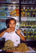 SINGAPORE, Chinatown, Herbalist store, vendor with scales, weighing dried herbs, SIN159JPL