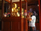 SINGAPORE, Little India, Leon San See temple, smiling Buddha figure, and worshipper, SIN283JPL