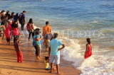 SRI LANKA, Colombo, Galle Face Green, people enjoying paddling on the beach, SLK5250JPL
