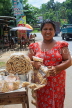 SRI LANKA, Kajugama (on Kandy Rd), Cashewnut vendor, traditional cloth and jacket dress, SLK2475JPL