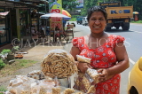 SRI LANKA, Kajugama (on Kandy Rd), Cashewnut vendor, traditional cloth and jacket dress, SLK2476JPL