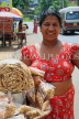 SRI LANKA, Kajugama (on Kandy Rd), Cashewnut vendor, traditional cloth and jacket dress, SLK2478JPL