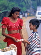 SRI LANKA, Kajugama (on Kandy Road), Cashewnut vendor, traditional cloth and jacket, SLK150JPL