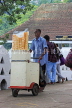 SRI LANKA, Kandy, Ice Cream vendor, pushing his trolly along lakeside, SLK3934JPL