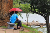 SRI LANKA, Kandy, Kandy Lake, courting couple by lakeside, SLK3729JPL