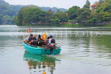 SRI LANKA, Kandy, Kandy Lake, people on boat tour, SLK3636JPL