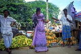 SRI LANKA, Kandy, Kandy Market, woman buying pineapple, SLK225JPL
