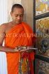 SRI LANKA, Kandy area, Asgiriya Monastery, monk with large ket to the image house, SLK3201JPL