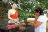 SRI LANKA, Kandy area, Degaldoruwa Cave Temple, Buddha statue, worshipper, SLK5787JPL