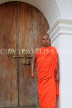 SRI LANKA, Kandy area, Degaldoruwa Cave Temple, Monk by entrance door, SLK5789JPL
