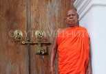 SRI LANKA, Kandy area, Degaldoruwa Cave Temple, Monk by entrance door, SLK5790JPL