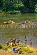 SRI LANKA, Kithulgala, rural scene, people crossing river in small catamaran, SLK355JPL