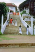 SRI LANKA, Matale, Aluvihare Rock Monastery, worshippers climbing steps, SLK1910JPL