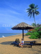 SRI LANKA, Negombo, beach with coconut trees and  boy on sunbed, SLK1606JPL