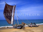 SRI LANKA, Negombo, fishermen pushing catamaran (with sail) out to sea, SLK169JPL