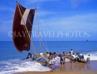 SRI LANKA, Negombo, fishermen pushing out catamaran (traditional fishing boat), SLK1609JPL