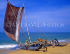 SRI LANKA, Negombo, fishermen pushing out catamaran (traditional fishing boat), SLK1643JPL