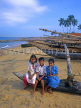 SRI LANKA, Negombo, fishing village, children posing on catamaran, SLK238JPL
