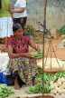 SRI LANKA, Negombo, market, fruit and vegetable market, vendor weighing Okra with scales, SK2715JPL