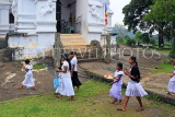 SRI LANKA, Pilimathalawa (nr Kandy), Lankatilaka Vihare, worshippers with flower offerings, SLK4136JPL