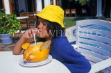SRI LANKA, girl drinking King Coconut water (Thambili), SLK222JPL