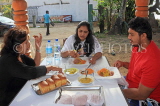 SRI LANKA, people enjoying a typical breakfast at a readside cafe, SLK4574JPL