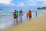 SRI LANKA, south coast, Bentota, people paddling along beach, SLK1686JPL