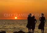 SRI LANKA, south coast, Gintota, people silhouetted against sunset, SLK2114JPL